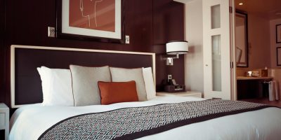 Cozy and modern hotel bedroom interior with elegant decor and soft lighting.